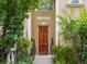 Charming exterior view of a carved wooden door with decorative plants adding to the curb appeal of the home at 425 Steele St, Denver, CO 80206