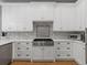 Bright kitchen boasts white cabinets, stainless appliances, and decorative backsplash at 425 Steele St, Denver, CO 80206