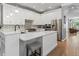 Island kitchen with stainless appliances, breakfast bar, and open to dining area at 425 Steele St, Denver, CO 80206