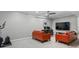 A finished basement features an orange sofa, exercise equipment, a drop ceiling, and recessed lighting at 425 Steele St, Denver, CO 80206