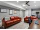 A finished basement living room features leather sofas, a drop ceiling, and recessed lighting at 425 Steele St, Denver, CO 80206