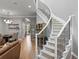 Spacious living room features a staircase with metal railing, hardwood floors, and an open layout at 425 Steele St, Denver, CO 80206