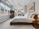 Large main bedroom features a fireplace, sitting area, neutral colors, and many windows at 425 Steele St, Denver, CO 80206