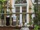 An outdoor patio with a stone railing, comfortable seating, and a blue and white rug at 425 Steele St, Denver, CO 80206