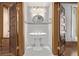 Elegant powder room featuring a pedestal sink, tiled walls, and hardwood door frames at 1034 N Logan St # 2W, Denver, CO 80203