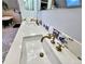 Bathroom featuring double sinks with bronze fixtures and decorative blue and white tiles at 1034 N Logan St # 2W, Denver, CO 80203