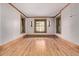 Bright bedroom featuring hardwood floors, wood trim, and windows with treetop views at 1034 N Logan St # 2W, Denver, CO 80203