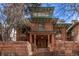 Charming three-story home featuring a brick facade, covered porch, and well-maintained landscaping at 1034 N Logan St # 2W, Denver, CO 80203