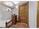 Elegant hallway with hardwood floors, detailed trim, and a decorative chandelier at 1034 N Logan St # 2W, Denver, CO 80203
