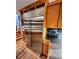A stainless steel refrigerator is adjacent to wood cabinets in this renovated kitchen at 1034 N Logan St # 2W, Denver, CO 80203