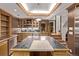 Kitchen with stainless steel appliances, custom cabinetry, and island with cooktop at 1034 N Logan St # 2W, Denver, CO 80203
