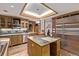 Kitchen featuring an island, stainless steel appliances, custom cabinetry, and a staircase nearby at 1034 N Logan St # 2W, Denver, CO 80203