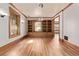 View of the living room with hardwood floors, stained glass windows, and custom shelving at 1034 N Logan St # 2W, Denver, CO 80203