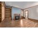 Cozy living room with fireplace, built-in bookcase, and bathroom access at 1034 N Logan St # 2W, Denver, CO 80203