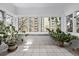 Bright sun room with windows looking out onto the city and potted plants at 1034 N Logan St # 2W, Denver, CO 80203