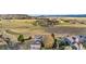 Aerial view of a neighborhood and open space with mountain views in the distance at 5090 Golden Valley Trl, Castle Rock, CO 80109