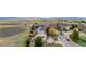 Aerial view of a suburban home surrounded by a fenced yard and a curving street at 5090 Golden Valley Trl, Castle Rock, CO 80109