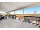 Spacious covered patio with lounge seating and hot tub overlooking a field at 5090 Golden Valley Trl, Castle Rock, CO 80109