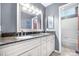 Bathroom with dual sink vanity, granite countertop, and a shower-tub combo at 5090 Golden Valley Trl, Castle Rock, CO 80109
