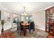 Elegant dining room with wood table, seating for six, a stylish cabinet, and a chandelier at 5090 Golden Valley Trl, Castle Rock, CO 80109