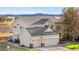 Two-story home with a three car garage, mature landscaping, and mountain views at 5090 Golden Valley Trl, Castle Rock, CO 80109