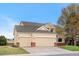 Spacious two-story home featuring a three-car garage and manicured lawn at 5090 Golden Valley Trl, Castle Rock, CO 80109