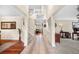 Bright and airy foyer with hardwood floors, staircase, and views into the living spaces at 5090 Golden Valley Trl, Castle Rock, CO 80109