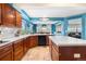 Eat-in kitchen provides generous counter space, updated appliances, and beautiful blue walls at 5090 Golden Valley Trl, Castle Rock, CO 80109