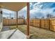 A fenced backyard with a covered patio and newly installed grass at 2187 S Fox St, Denver, CO 80223