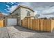 Two-story home featuring a garage and a fenced yard at 2187 S Fox St, Denver, CO 80223