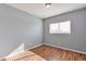 Cozy bedroom featuring a window, hardwood floors, and light gray walls at 11069 York St, Northglenn, CO 80233