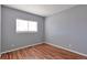 Cozy bedroom with a window and wood-look flooring at 11069 York St, Northglenn, CO 80233
