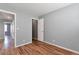 Bedroom with light gray walls, hardwood floors, and two doorways at 11069 York St, Northglenn, CO 80233