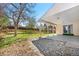 View of covered back patio with grass area and wooden garden beds in backyard at 5556 S Sedalia St, Centennial, CO 80015