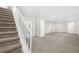 Finished basement with plush carpeting and a staircase at 5556 S Sedalia St, Centennial, CO 80015