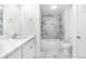 Beautiful bathroom featuring marble tile, modern fixtures, and a shower-tub combination at 5556 S Sedalia St, Centennial, CO 80015