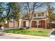 Traditional two-story home with red shutters, mature trees, lawn and two car garage at 5556 S Sedalia St, Centennial, CO 80015