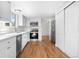 Bright kitchen with white cabinets, stainless steel appliances, and hardwood floors at 5556 S Sedalia St, Centennial, CO 80015