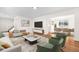 Bright living room with hardwood floors, contemporary furnishings, and open to dining area at 5556 S Sedalia St, Centennial, CO 80015