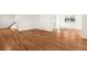 Unfurnished living room featuring lustrous hardwood floors, white walls and a staircase at 5556 S Sedalia St, Centennial, CO 80015