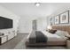 Staged main bedroom featuring plush carpet, a king bed, and ensuite access at 5556 S Sedalia St, Centennial, CO 80015