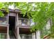 Relaxing outdoor balcony featuring comfortable seating, complemented by the surrounding natural beauty and sunlight at 830 S Vance St # F, Lakewood, CO 80226