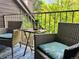 Inviting balcony with chairs, side table, and nature views for outdoor enjoyment at 830 S Vance St # F, Lakewood, CO 80226