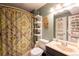 Cozy bathroom featuring a toilet, shower with curtain and shelf with supplies at 830 S Vance St # F, Lakewood, CO 80226