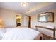 Bedroom featuring wood floors, a full sized mirror and access to the connected bathroom at 830 S Vance St # F, Lakewood, CO 80226