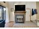 Contemporary fireplace with a mounted TV, complemented by wood floors, and a bright door leading to outside at 830 S Vance St # F, Lakewood, CO 80226