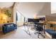 Home office space illuminated by a large window, accompanied by a comfortable chair and table at 830 S Vance St # F, Lakewood, CO 80226