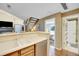 Bright kitchen with stainless steel dishwasher and view into the living room and upstairs bedroom at 830 S Vance St # F, Lakewood, CO 80226