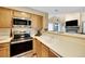 Bright kitchen featuring stainless steel appliances, updated countertops, and ample cabinet space, ideal for cooking and entertaining at 830 S Vance St # F, Lakewood, CO 80226