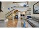 Open-concept living room with a staircase leading to a loft area, alongside a modern kitchen and comfortable seating at 830 S Vance St # F, Lakewood, CO 80226